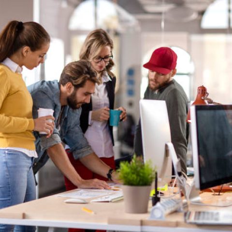 Four colleagues working together in the office